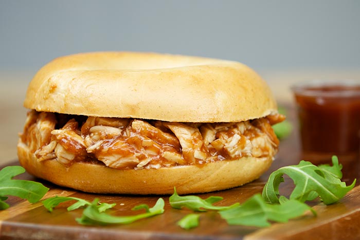 Bagel filled with pulled chicken in barbecue sauce