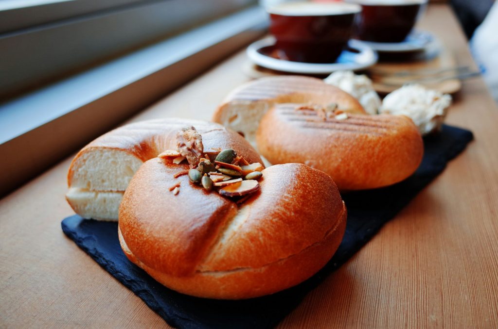 Bagels with seeds and nuts on a wooden board