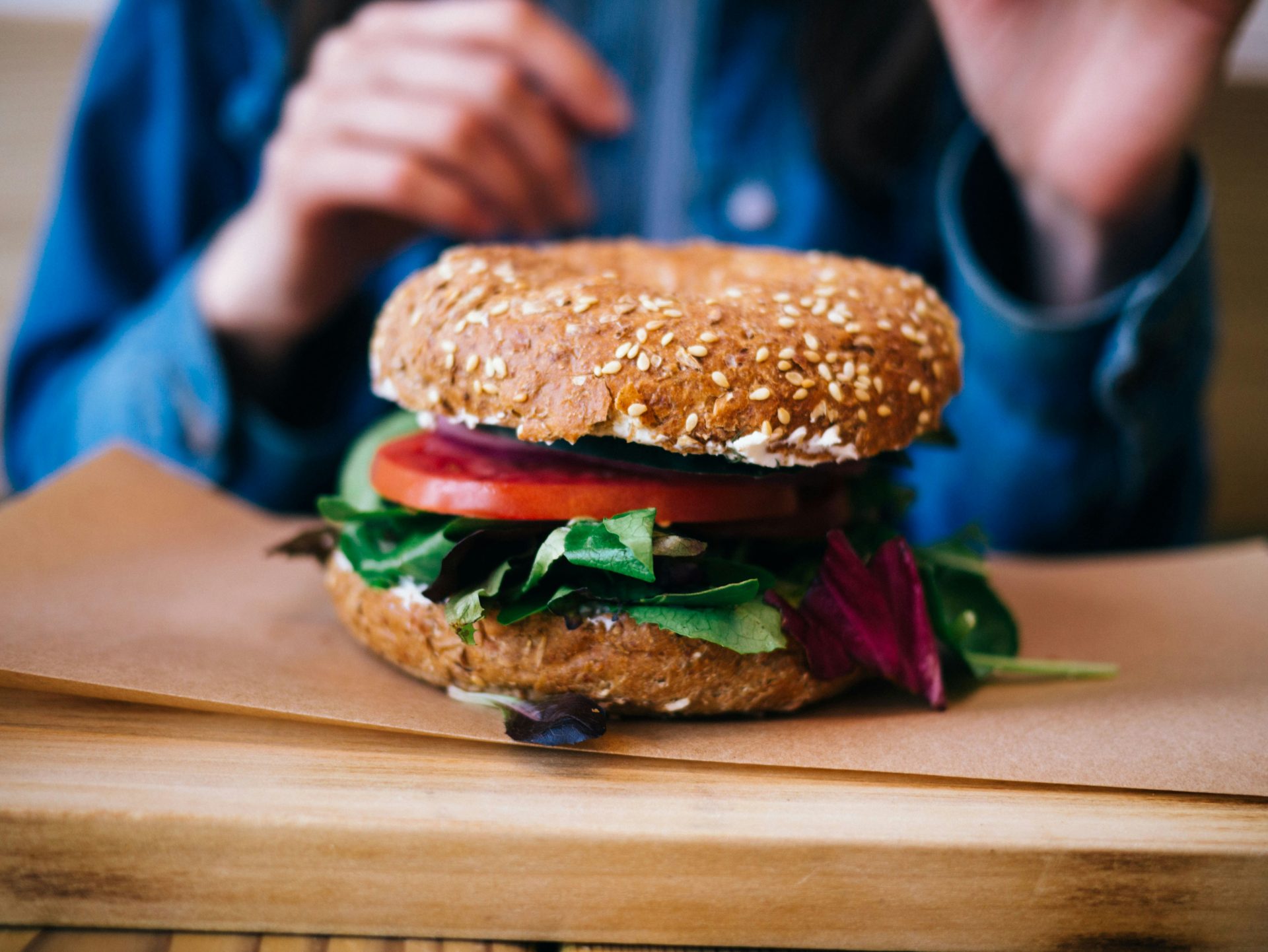 Bagel sandwich with fresh vegetables and leafy greens